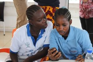 (A-LIFE) girls learn how to record survey data on their mobile phones as part of U-Report (UNICEF photo).