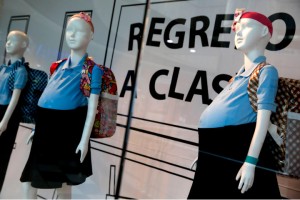 Mannequins of pregnant schoolgirls are seen in a shop window at a shopping mall in Caracas